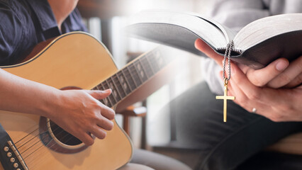 Musician is sitting and playing an acoustic guitar and Christian praying, reading bible in his or...