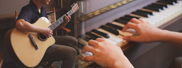 Concept of musical class, School course study banner, poster background, widescreen for advertisement. Guitar and piano player. Practice guitar and piano.