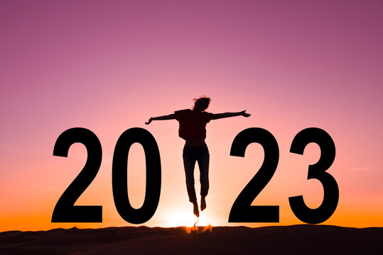 2023, silhouette of a woman jumping in the sunrise, women new year greeting card