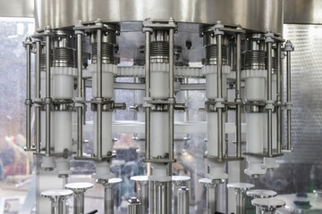 Industrial bottling machine at modern wine factory. Automatic conveyor line for wine-producing