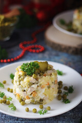 Olivier salad, traditional Russian dish, served on the plate for New Year dinner