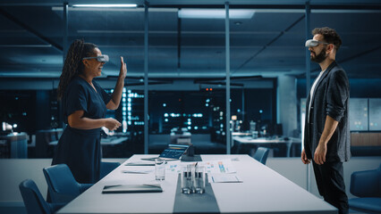 Office Online Meeting Video Conference Call: Businesswoman and Businessman Wearing Virtual Reality Glasses Talk using Augmented Reality Metaverse. Ultra Realistic Hologram of Virtual Employee Concept.
