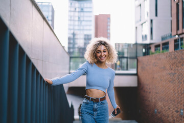 Carefree ethnic woman going up stairs