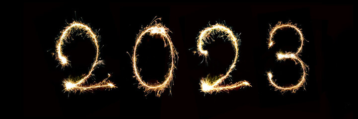 2023 written with sparkler firework, new year header or web banner