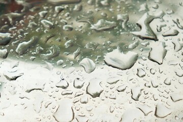 Rain water drops on shiny chrome metal surface