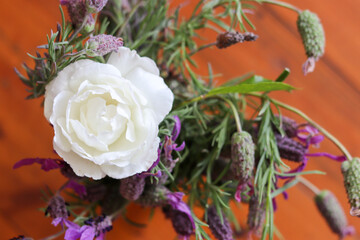 Natural flowers bouquet, white roses in a blur wooden background