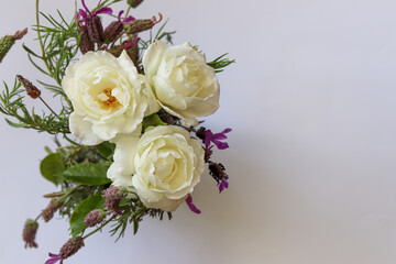 white roses bouquet in a white background with copy space