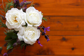 Natural white flowers bouquet in wooden background