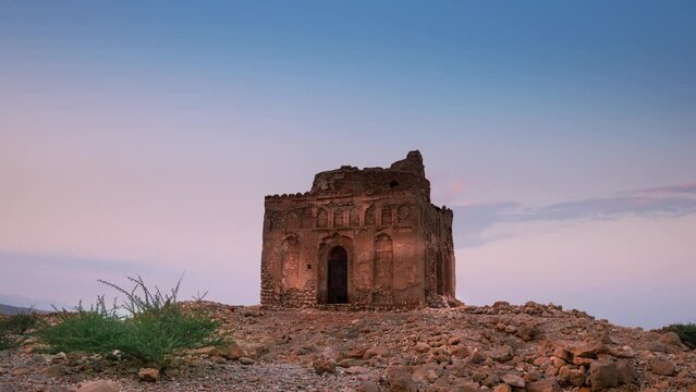 4k Time lapse of sunset sky at Bibi Mariam's Tomb at Qalhat ruins, Oman