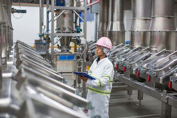 Male worker inspection the process of food drink at the manufacturing vertical factory stainless. - Powered by Adobe