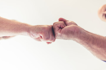 Shot of two unrecognizable businesspeople giving a fist bump outside. Fist bump teamwork, motivation and collaboration or hands emoji sign for commitment, solidarity and goal.