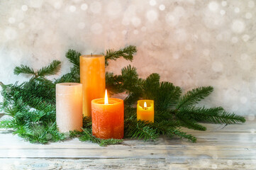 Second Advent, arrangement with four candles in orange and yellow, two are lit with a flame, fir...