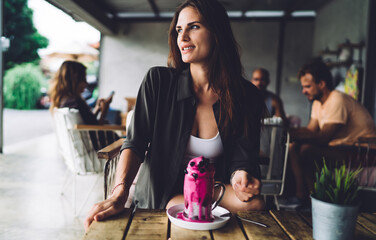 Content woman enjoying dessert in cafeteria