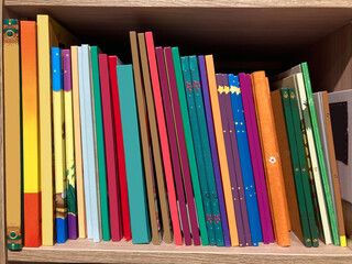 Heap ofcolorful  books on the book shelf mockup