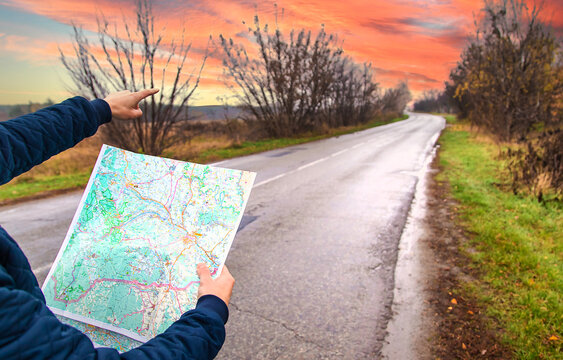 A man looks at a map on the road. Selective focus.