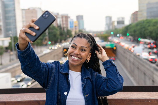 Crop black woman taking a selfie photo on smartphone