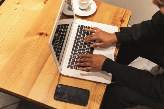 Anonymous Black Woman Typing On Laptop While Having Coffee