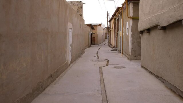Narrow streets of a residential quarter in old Bukhara in Uzbekistan. Arab streets with residential buildings.