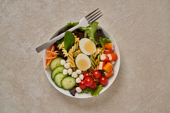 Bowl with salad assortments with fork