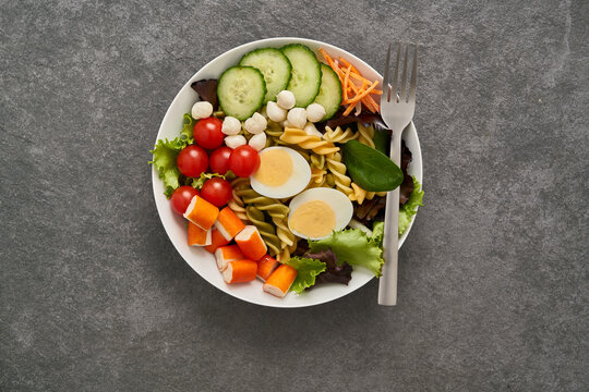 Bowl with salad assortments with fork