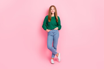 Full length photo of confident adorable young lady wear green sweater arms pockets isolated pink color background