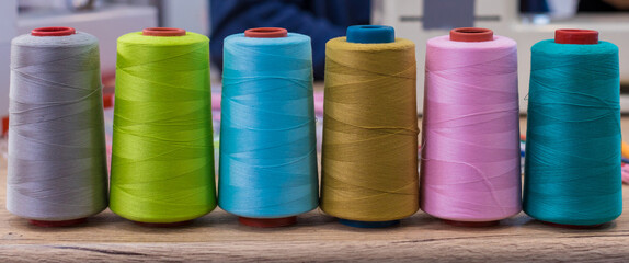 Spool of sewing thread. Multicolor sewing threads. Colored sewing threads.