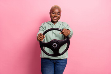 Photo of adorable young lady holding steering wheel drive to repair shop isolated on pink color background