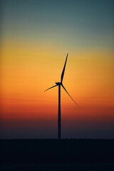 Windmill farm park in silhouettes with colorful sky.