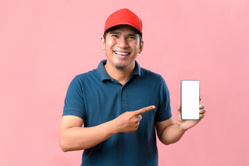 Portrait of Happy Asian delivery man showing phone screen and pointing at phone screen