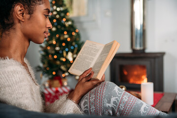 Woman reading book in cozy room