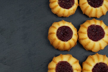 Graham cracker cookies with berry jam .Dessert, dark gray concrete background with copy space