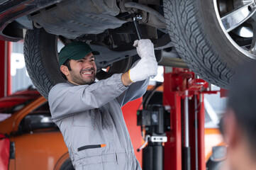 Professional mechanic providing car repair and maintenance service in auto garage. Car service business concept.