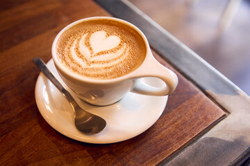Close Up Of Cup Of Coffee On Table In Cafe Showing Foam Art Decoration