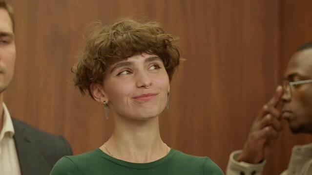 Zoom in portrait of Caucasian female office worker dreaming of something pleasant while riding in the elevator to or from work