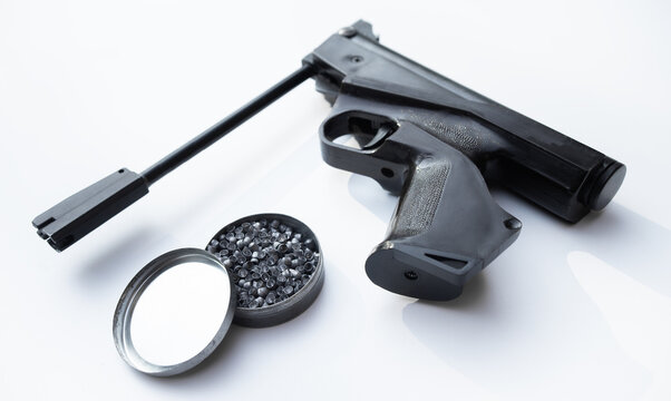Pneumatic pistol with lead pellets on a white background.Training pistol shooting.