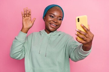 Photo of charming woman social media blogger have online stream say hi to her subscribers isolated on pink color background © deagreez