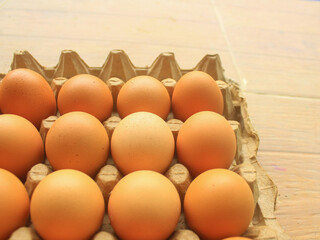 Raw chicken eggs in carton tray, closeup