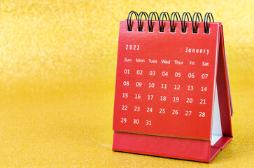 The Red January 2023 Monthly desk calendar for 2023 year on golden color background.