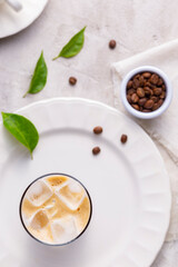 Refreshing iced coffee, with roasted coffee beans, on white background