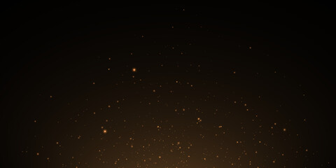 Christmas festive background of light confetti and small shining golden lights on a black background. Shiny golden texture. Christmas effect for luxury greeting card.