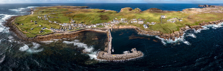 Aerial view of the settlement An Baile Thiar or West Town on Tory Island and harbour, County...