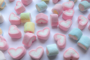 Colorful marshmallows on a white background. Pastel colored marshmallow candies pattern on white background.  Valentine's day concept. Life is sweet marshmallows concept.