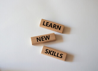 Learn new skills symbol. Concept words Learn new skills on wooden blocks. Beautiful white background. Business and Learn new skills concept. Copy space.