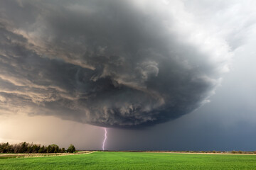 Obraz na płótnie Canvas storm clouds over a field
