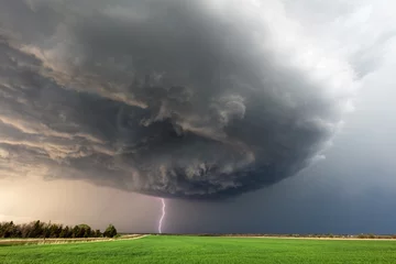 Fotobehang storm clouds over a field © JSirlin