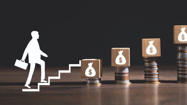 Businessman walking up to money bag.