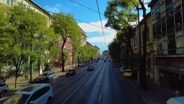 Flying around the streets of Budapest, Hungary on top of a bus on a sunny day 