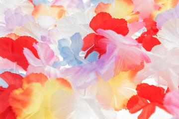 Obraz na płótnie Canvas Colorful plastic hawaii flowers. Colorful background
