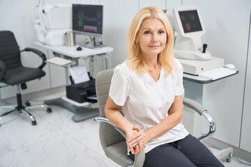 Lady working in the hospital, looking at the camera