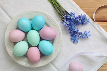festive table with Easter eggs and spring flowers, top view. flat lay.